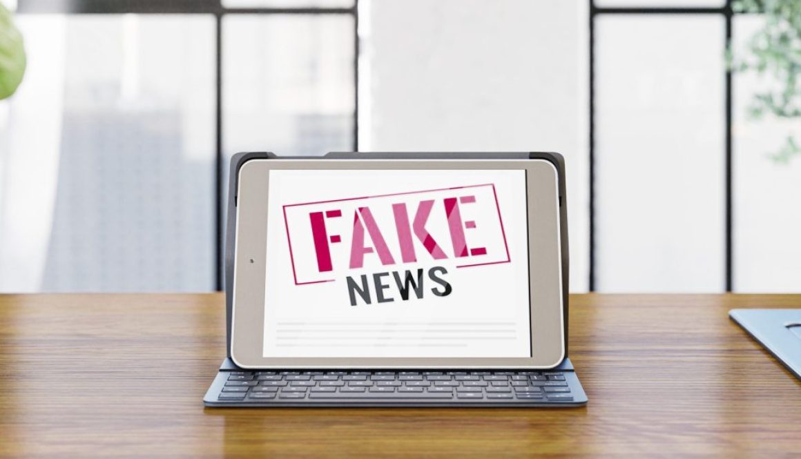 front-view-laptop-desk-with-fake-news